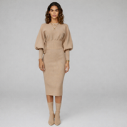 woman wearing beige formal midi dress paired with grey boots on a plain background