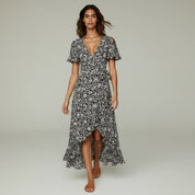 lady in black maxi dress on a plan background