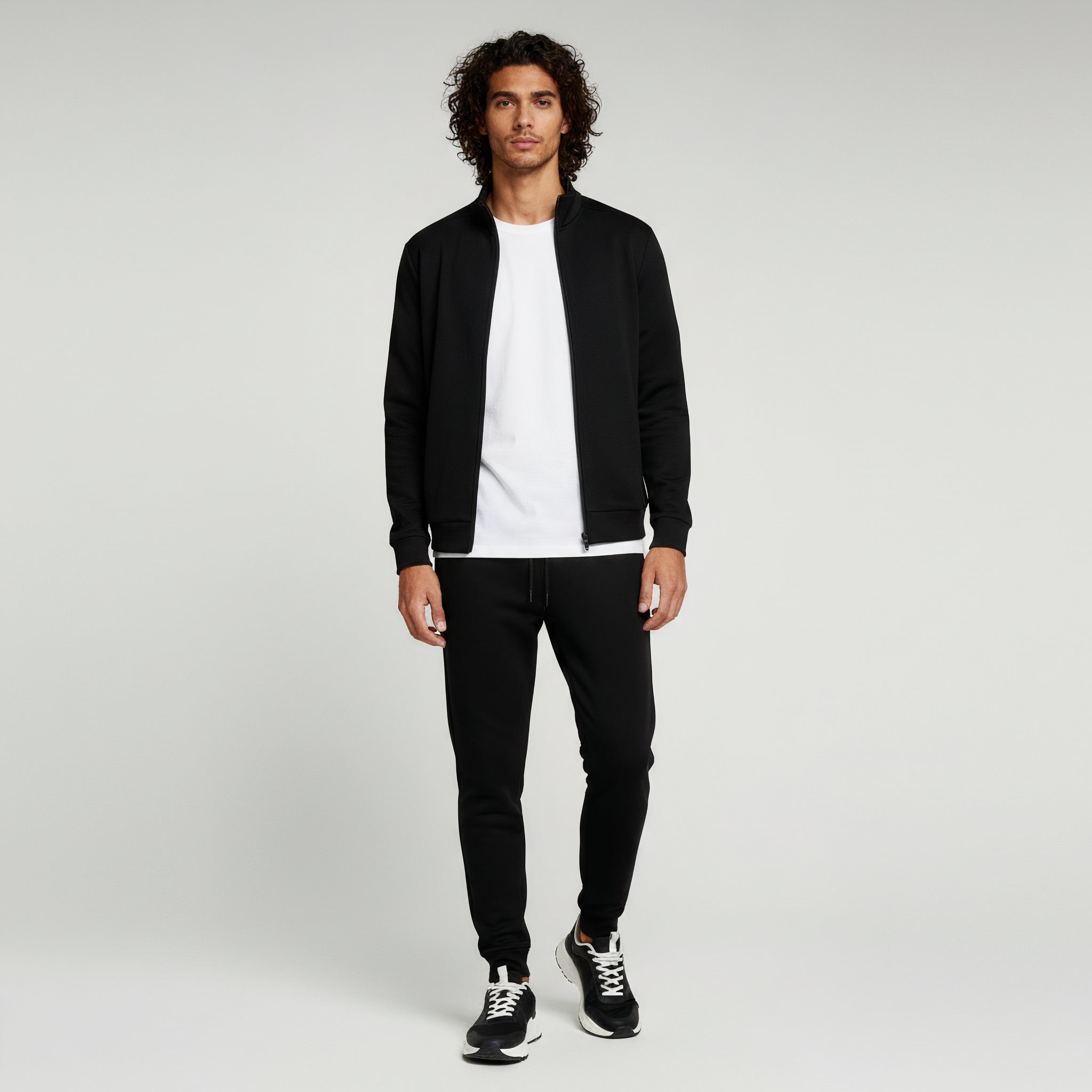 man wearing black 2piece set on a plain background