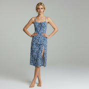 lady in blue floral sleeveless  midi dress on a plain background