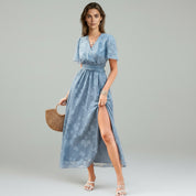 Lady in Blue maxi dress on a plain background