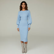 woman wearing formal midi dress paired with grey boots on a plain background