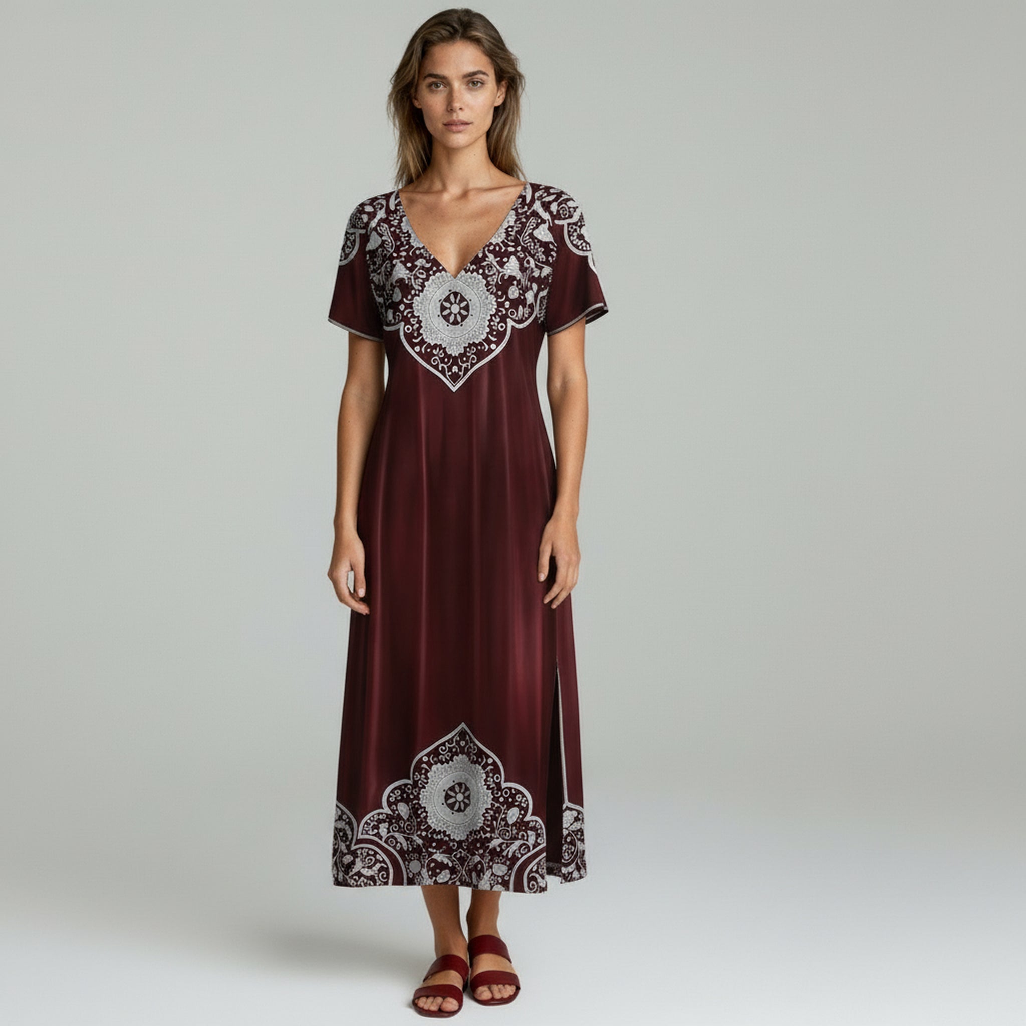 woman wearing burgundy summer dress on a plain background