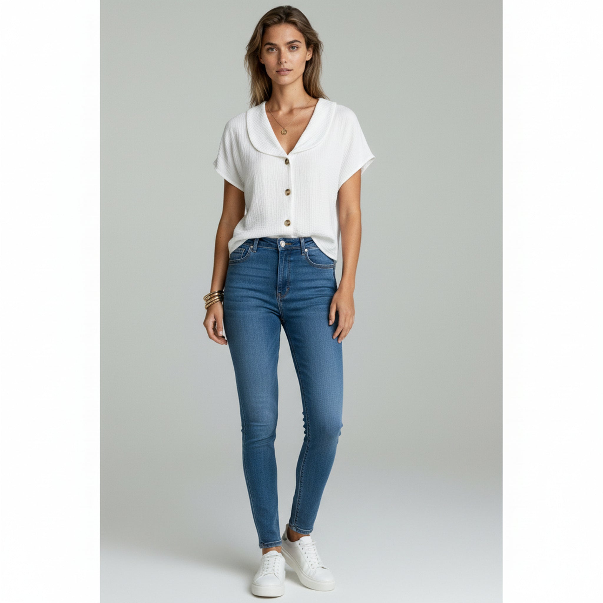 lady wearing white button-up blouse and pants on a plain background