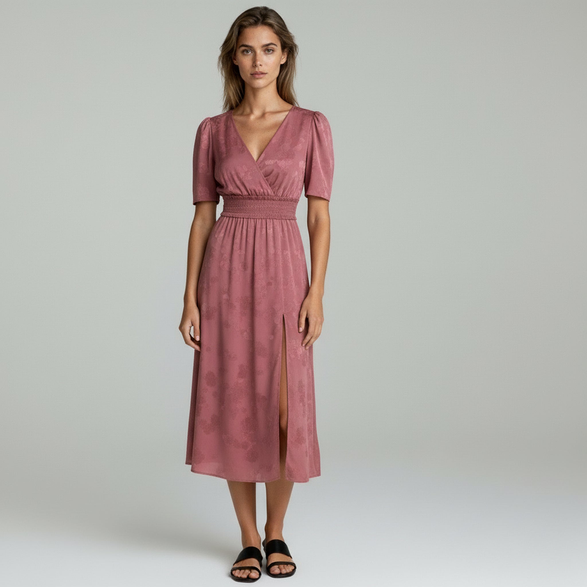 lady in dark blush flowy maxi dress on a plain background