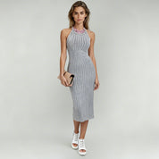 lady in gray halter neck midi dress on a plain background