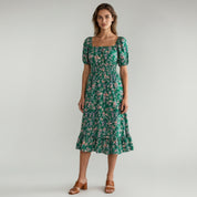 woman wearing green Flowy maxi dress on a plain background