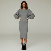 woman wearing Grey formal midi dress paired with black boots on a plain background