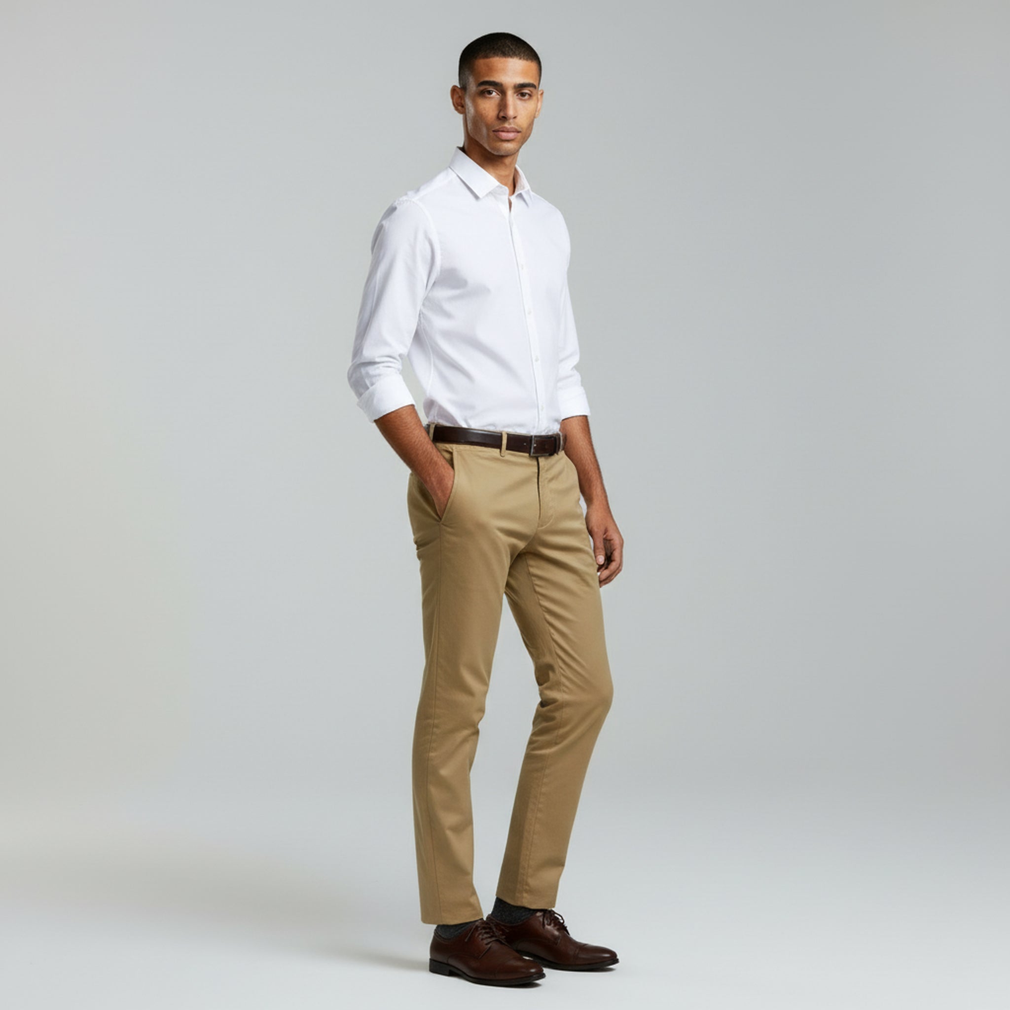 man wearing white long sleeve polo and Khaki pants on a plain background