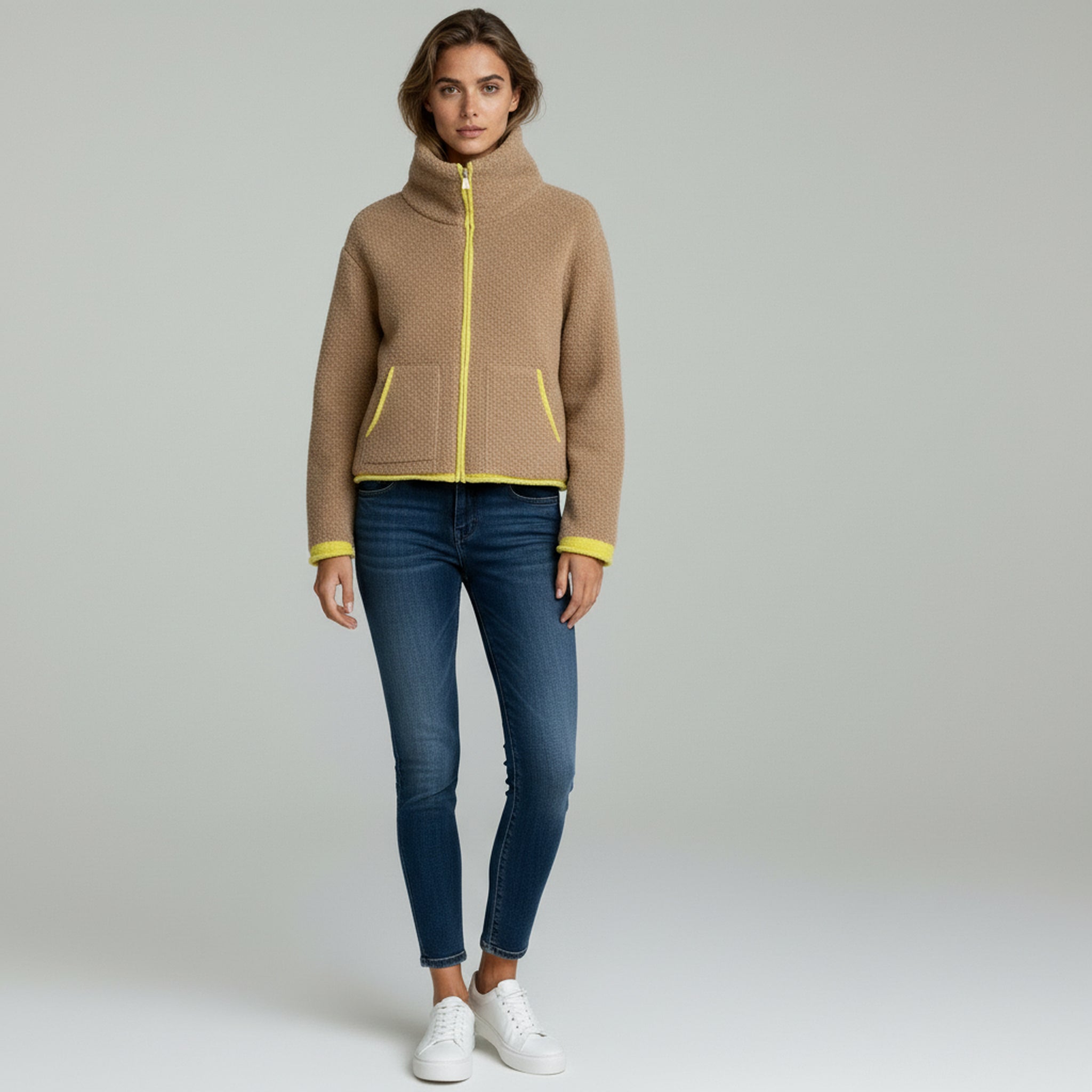 lady in khaki jacket and pants on a plain background