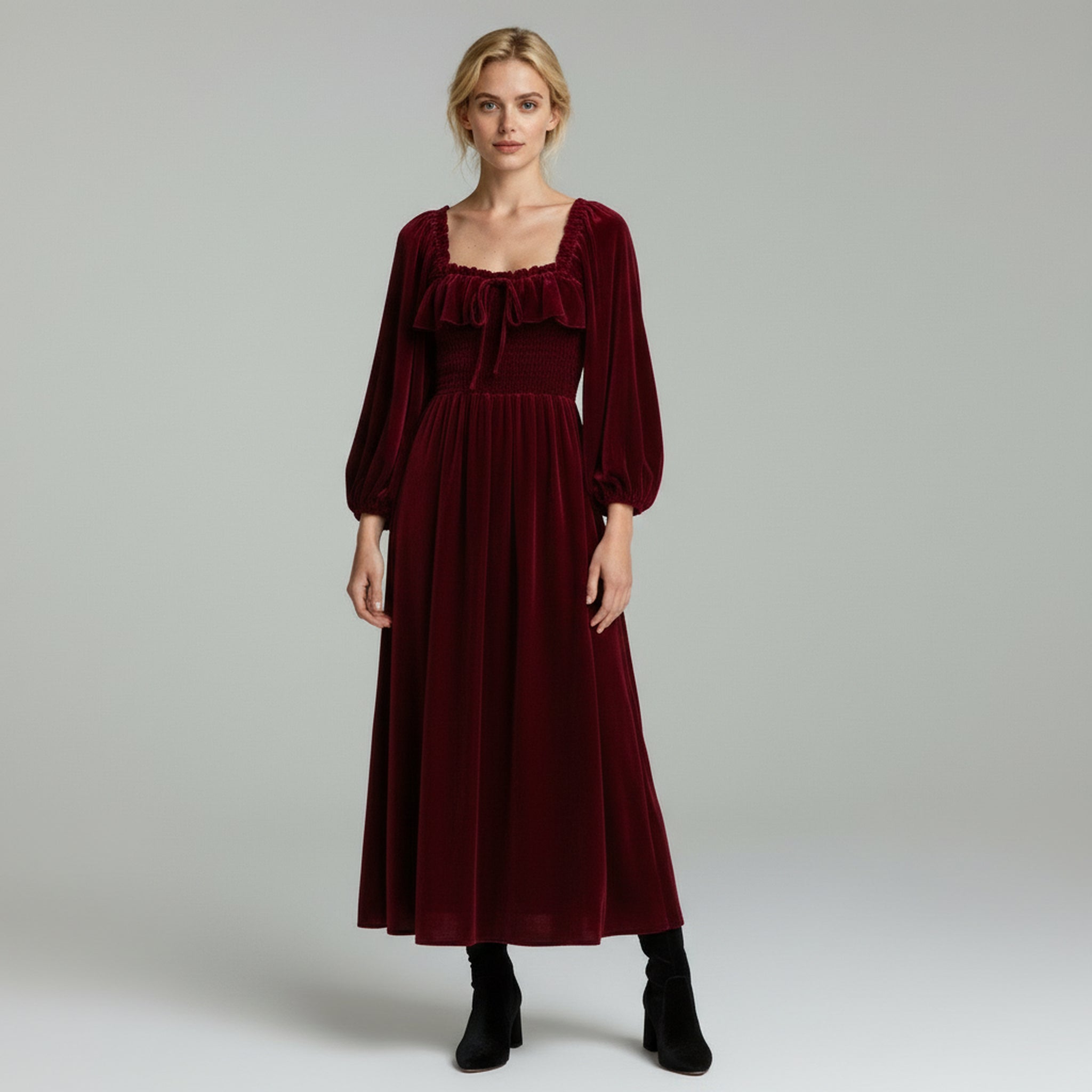 lady in dark red maxi dress on a plain background