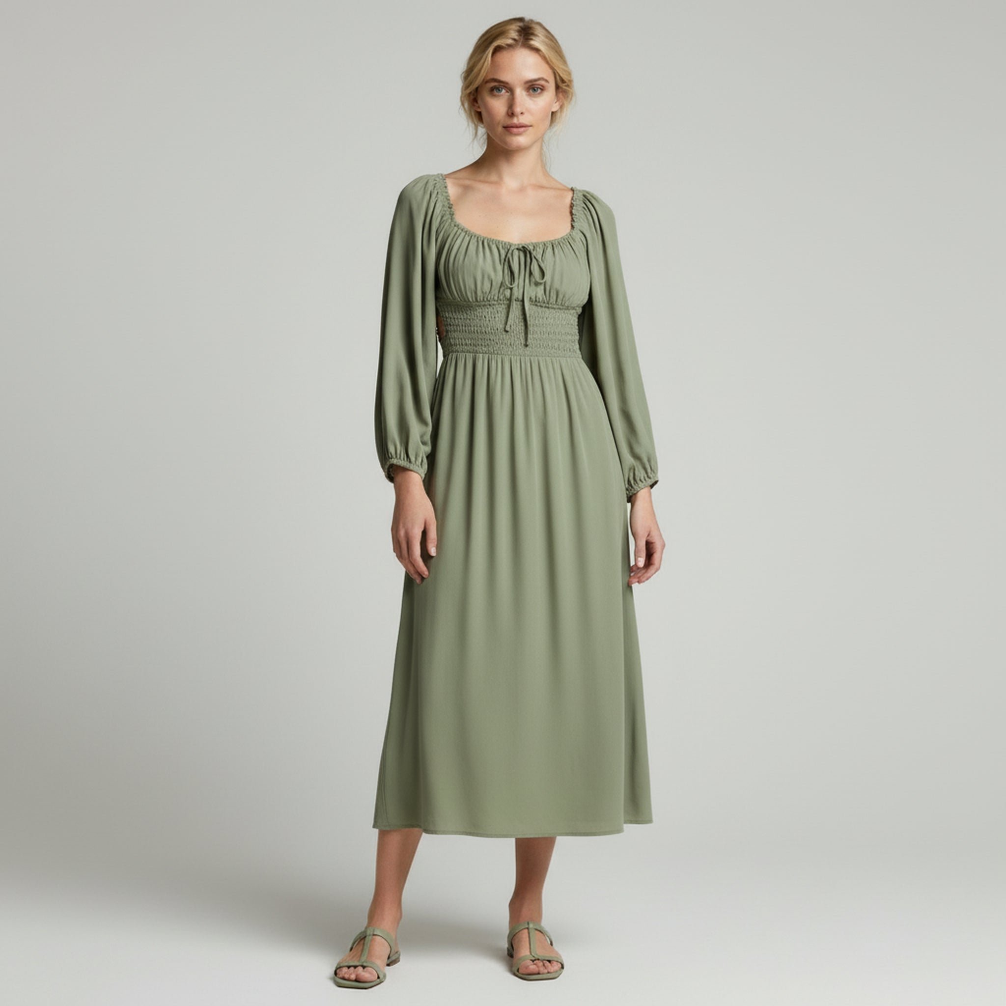 lady in green maxi dress on a plain background