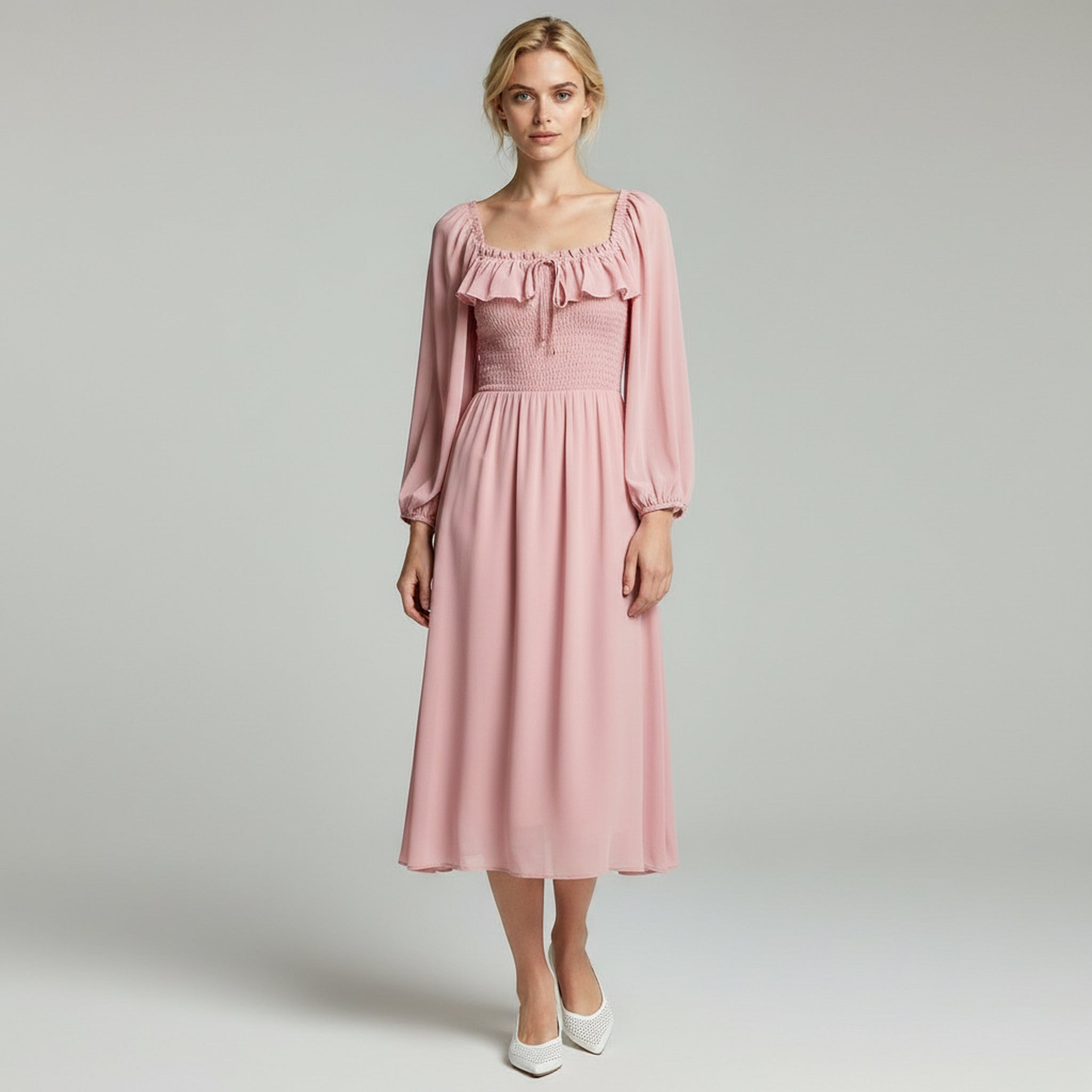 lady in pink long sleeve maxi dress on a plain background