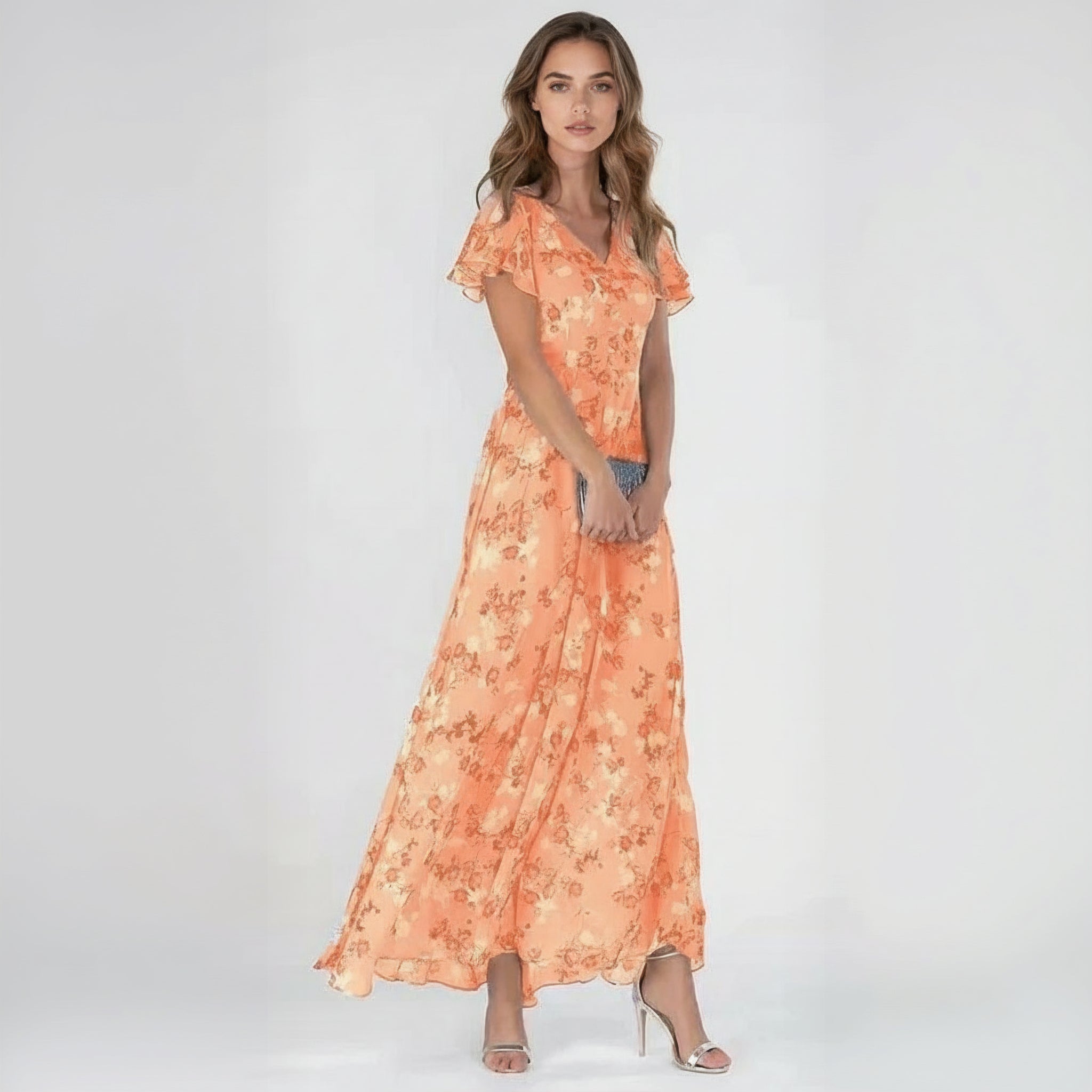 woman wearing orange maxi dress on a plain background