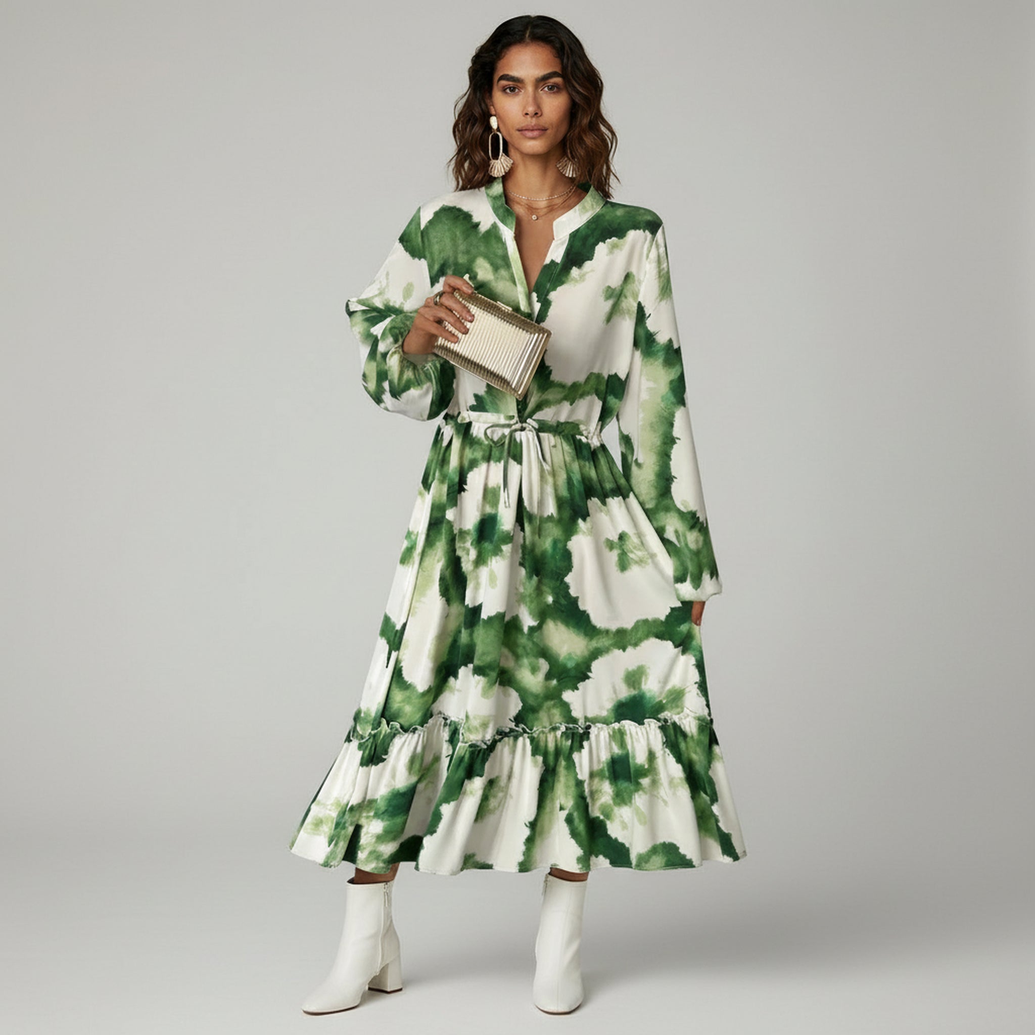 woman wearing green maxi dress on a plain background