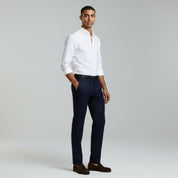 man wearing white long sleeve polo and Navy-Blue pants on a plain background