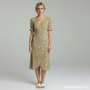 woman wearing olive green puff sleeves midi dress on a plain background