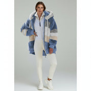 woman wearing white top with Oversized Jacket paired with white pants on a plain background