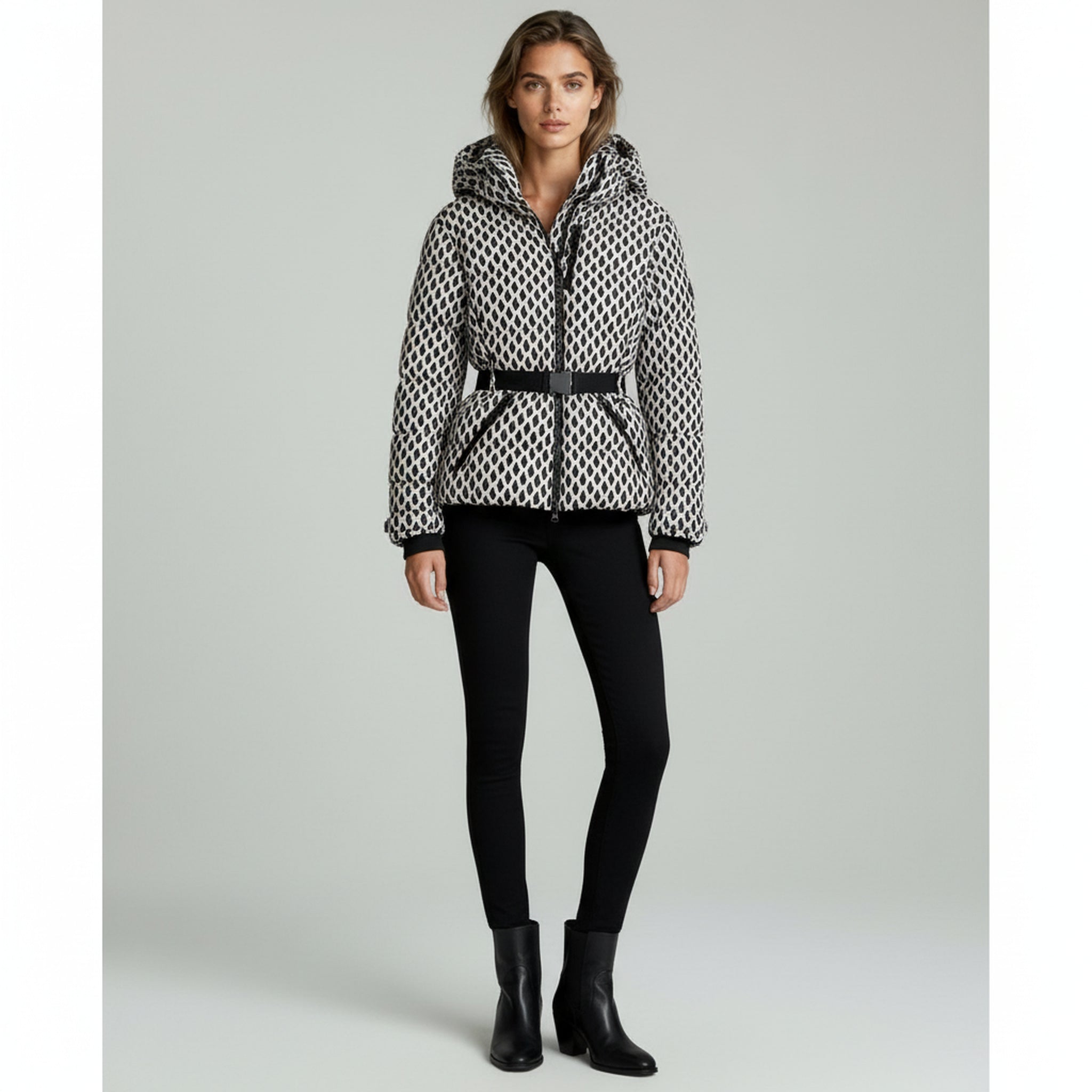 lady wearing padded jacket and black pants on a plain background