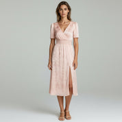 Lady in pink Maxi dress on a plain background