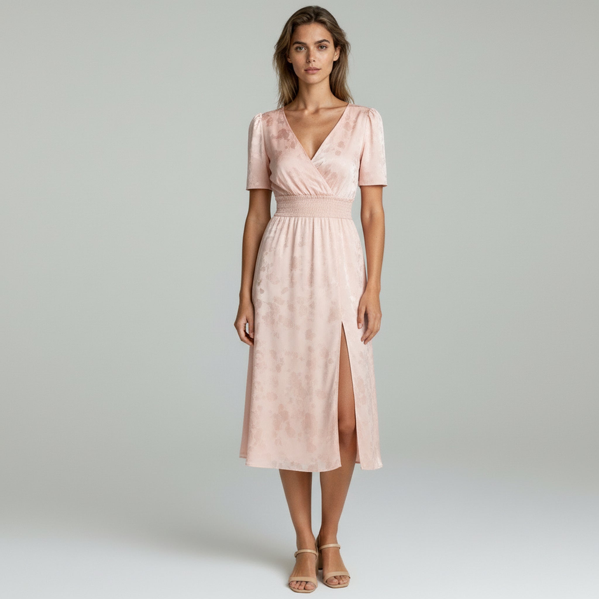 Lady in pink Maxi dress on a plain background