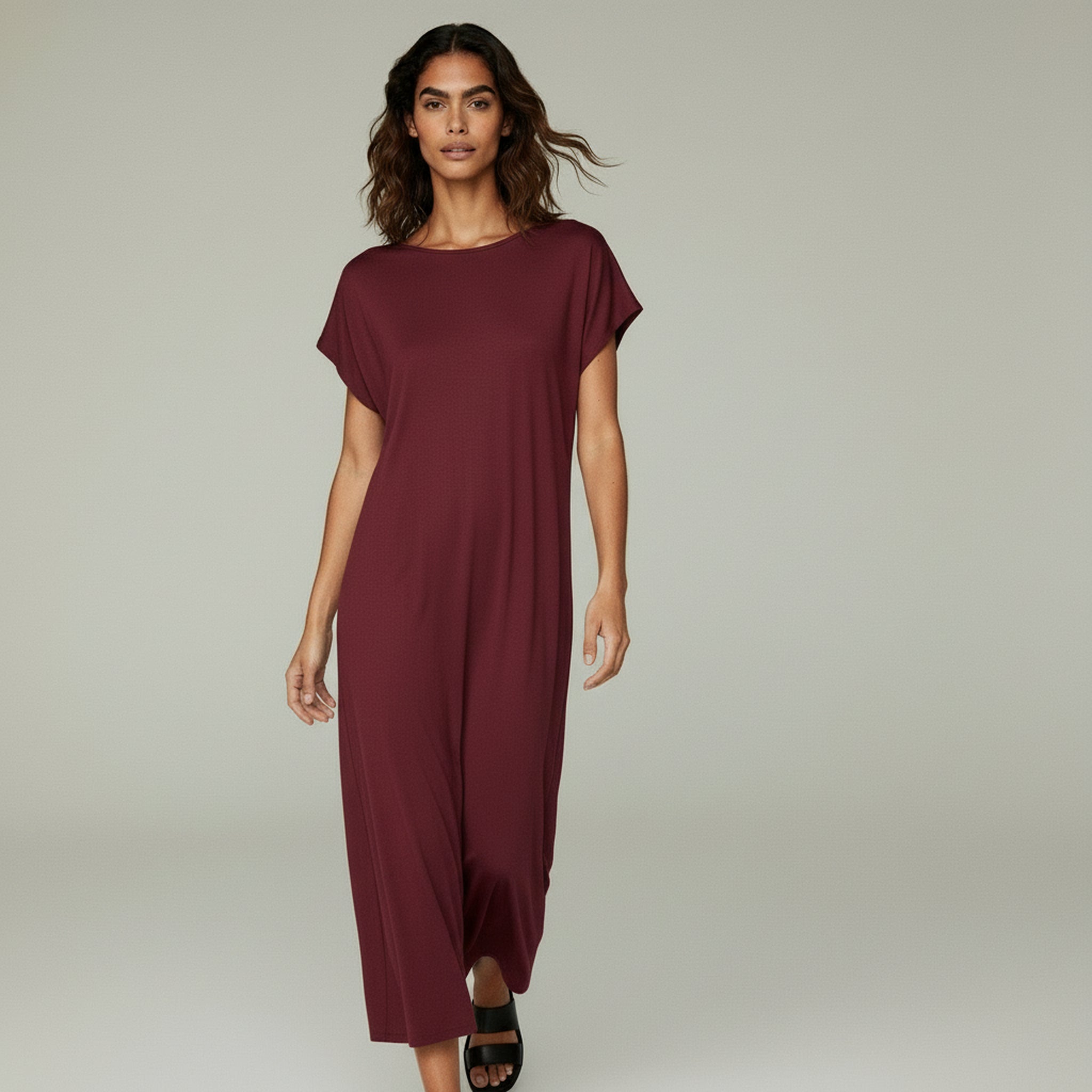 woman wearing red midi cocktail dress on a plain bakcground