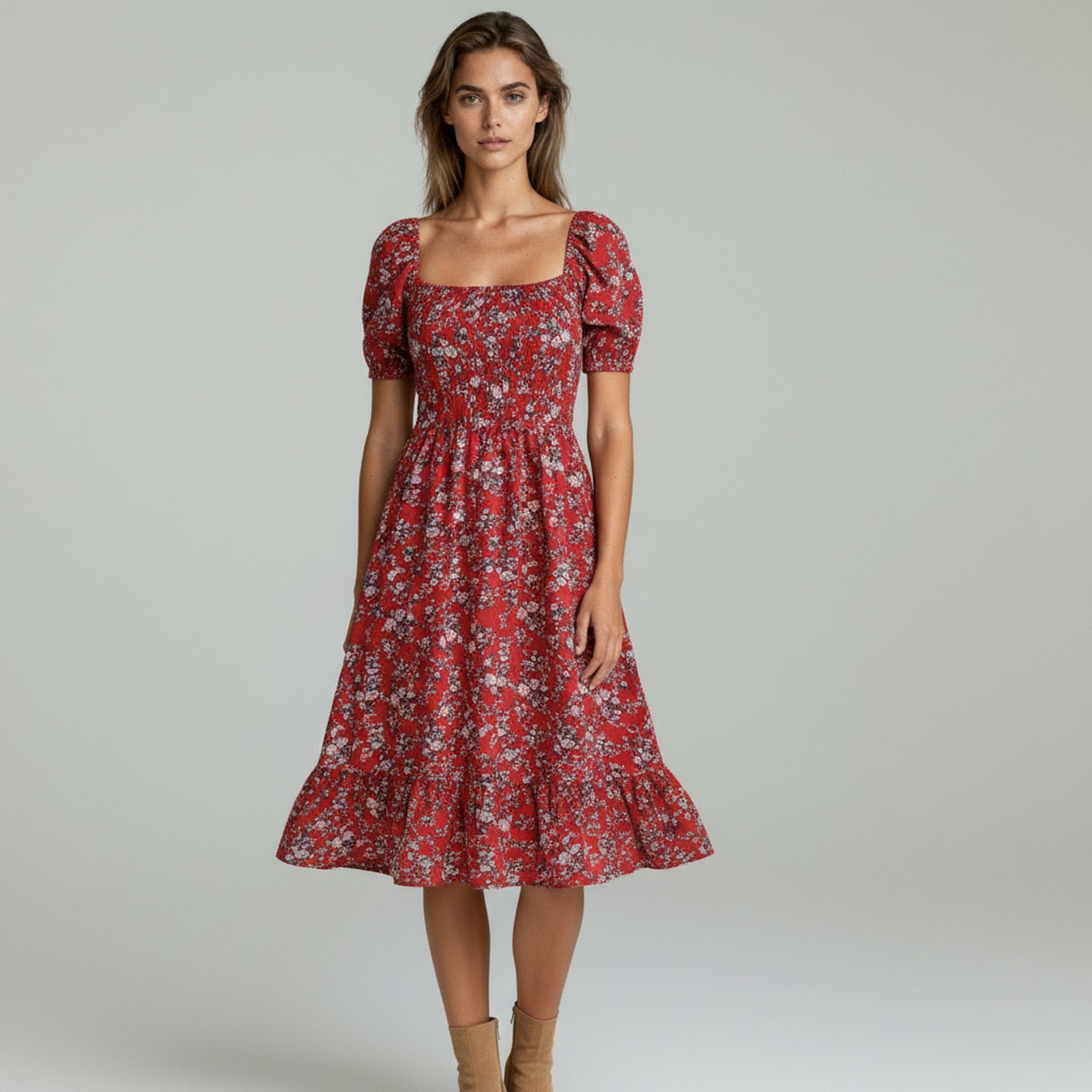 lady in red flowy maxi dress on a plain background