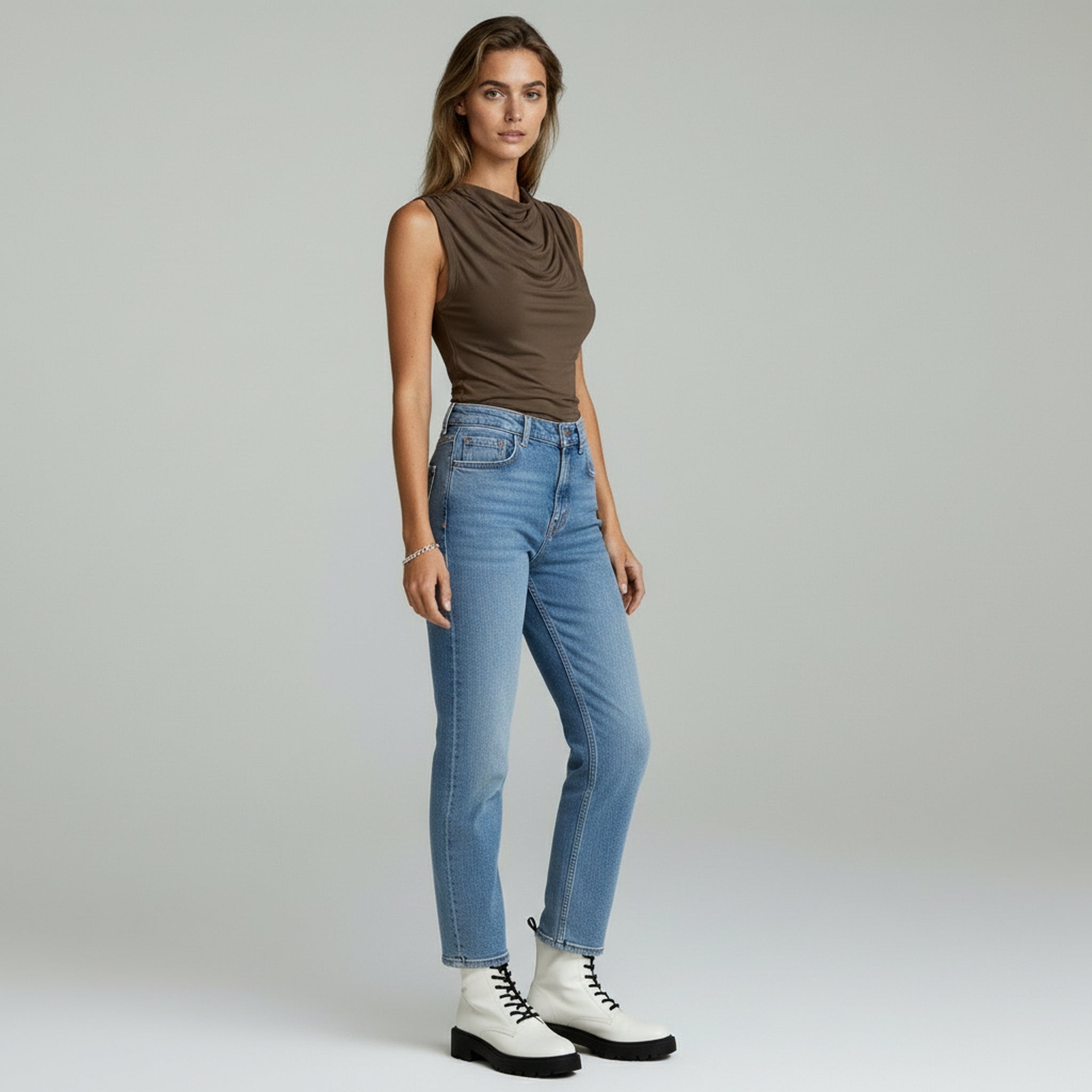 lady wearing brown sleeveless top and pants on a plain background