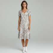 woman wearing beige summer dress on a plain background