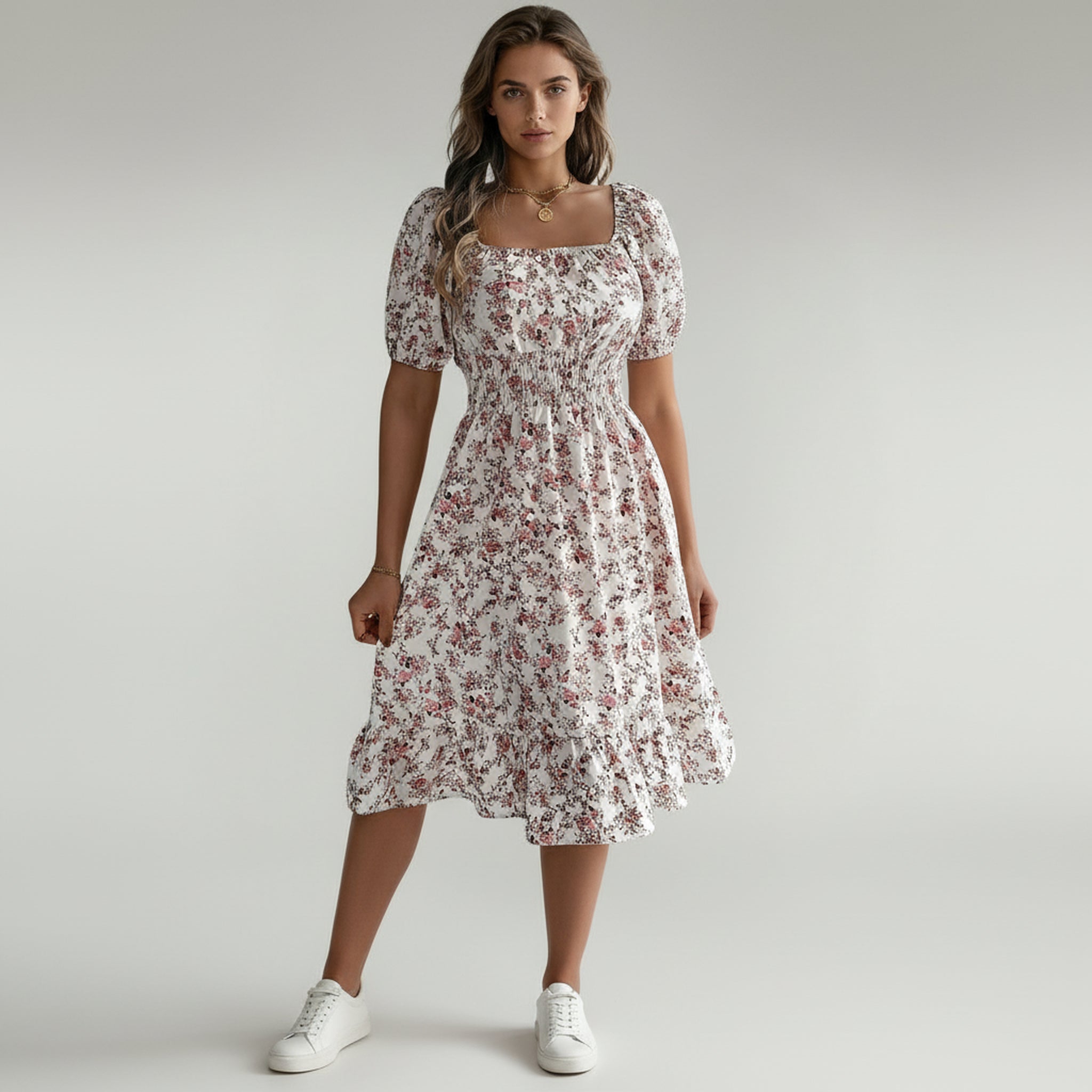 lady in white floral maxi dress on a plain background