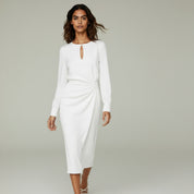 woman wearing white long sleeve formal maxi dress on a plain background