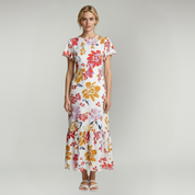 woman wearing white with red maxi dress on a lain background