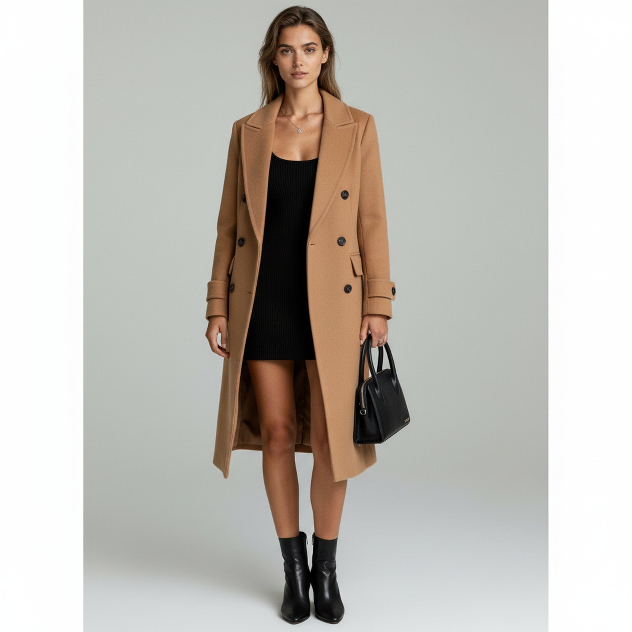 woman wearing black fitted dress with elegant brown long coat on a plain background