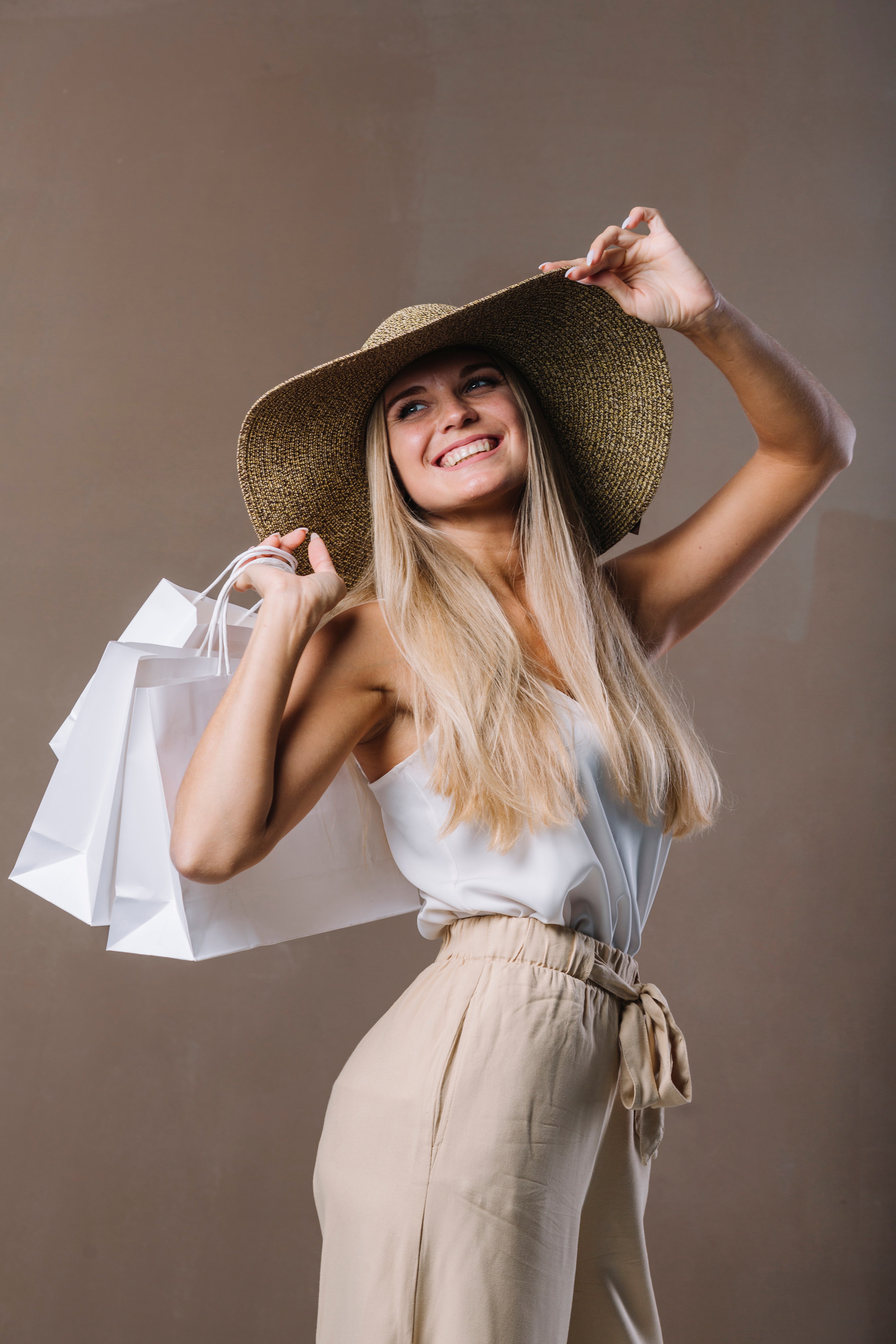 beautiful-young-woman-holding-shopping-bags.jpg