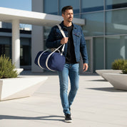 Man walking outdoors holding a blue duffel bag